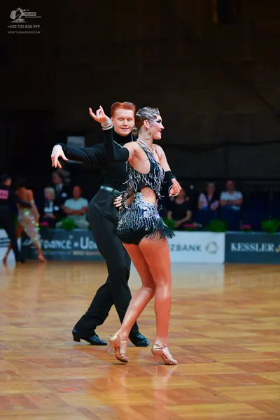 Dancesport competitor: Male dancer: black long-sleeved top and black trousers
