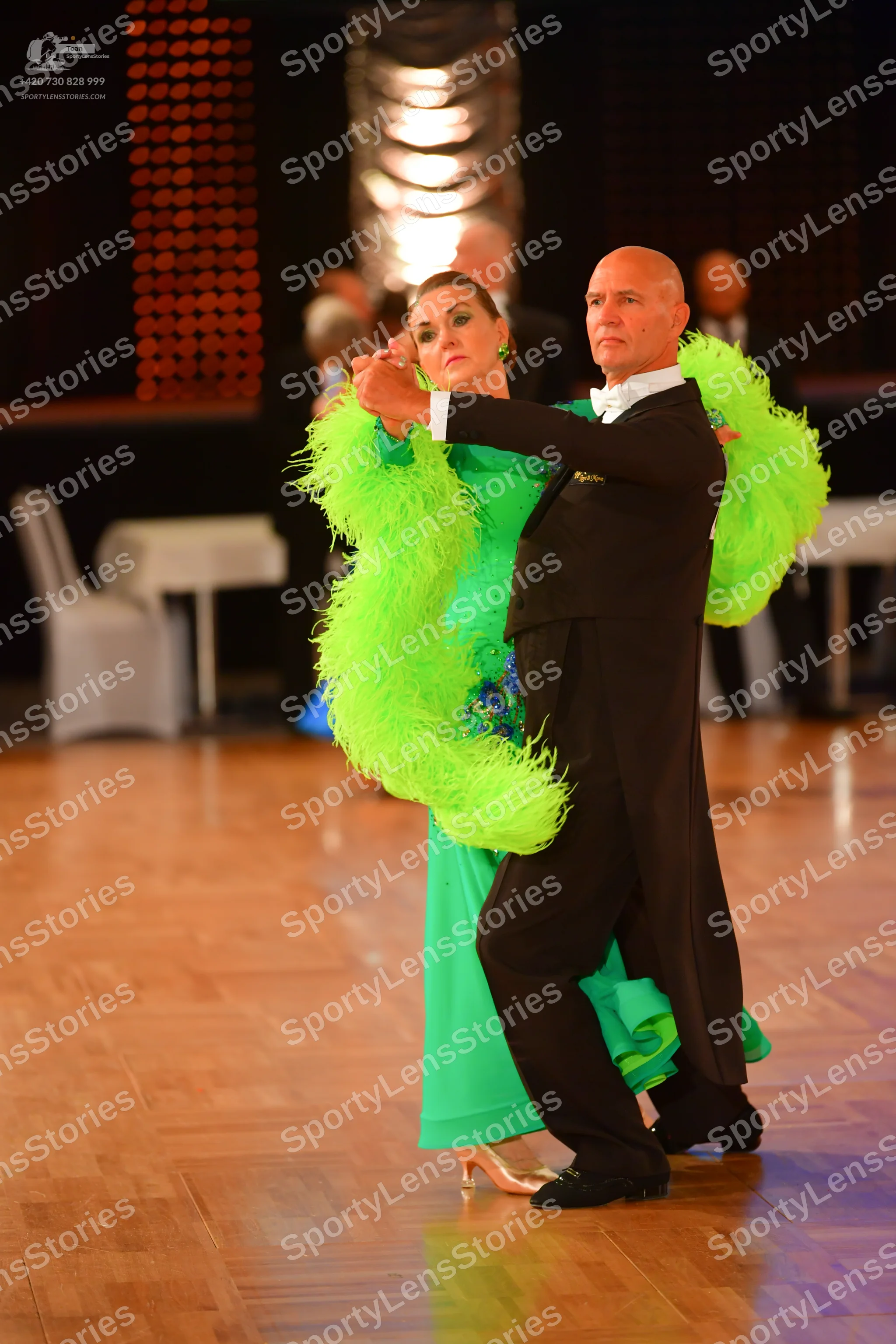 Dancesport competitor: Male dancer: black ballroom suit with a white shirt and white bow tie