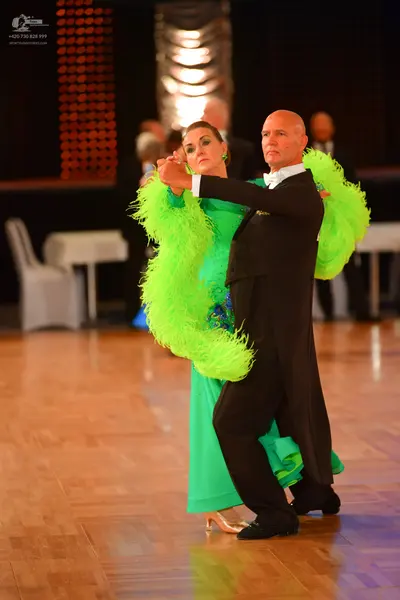 Dancesport competitor: Male dancer: black ballroom suit with a white shirt and white bow tie