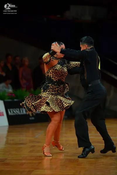 Dancesport competitor: Male dancer: black long-sleeved shirt and black trousers
