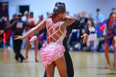Dancesport competitor: Male dancer: black long-sleeved shirt and black trousers