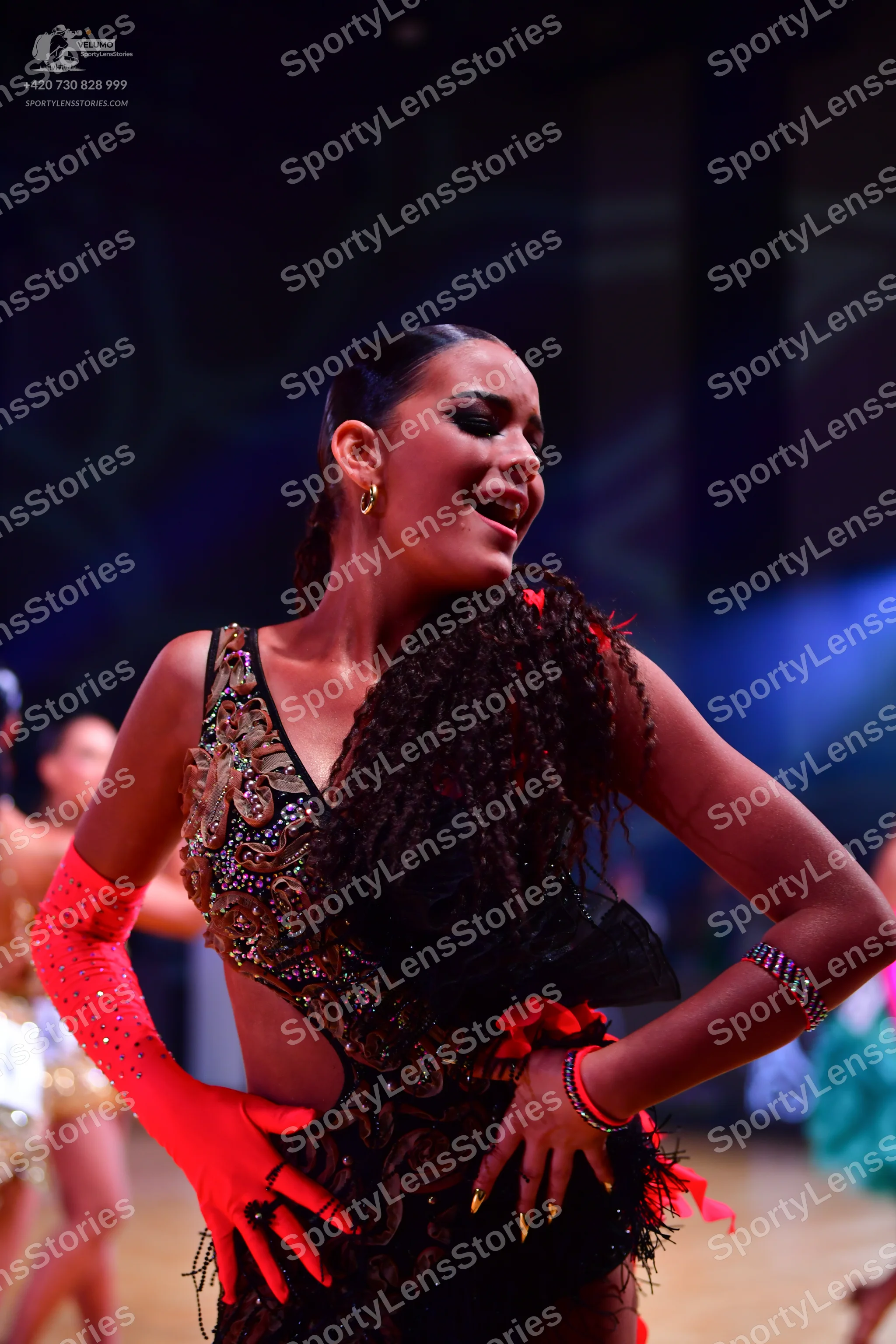 Dancesport competitor: Main female dancer: black latin dress with heavy gold and bronze sequin embellis