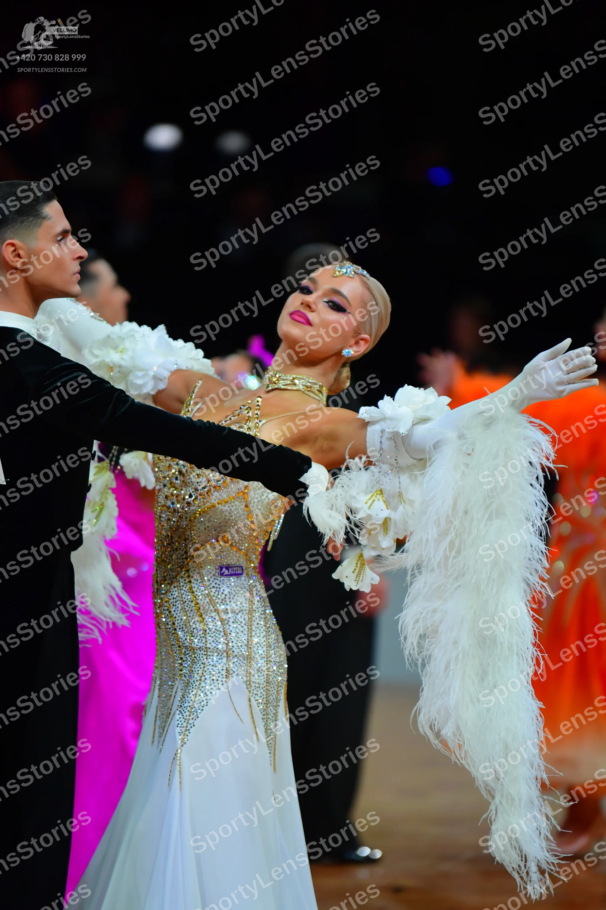 Dancesport competitor: Male dancer in foreground: black suit