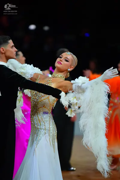 Dancesport competitor: Male dancer in foreground: black suit