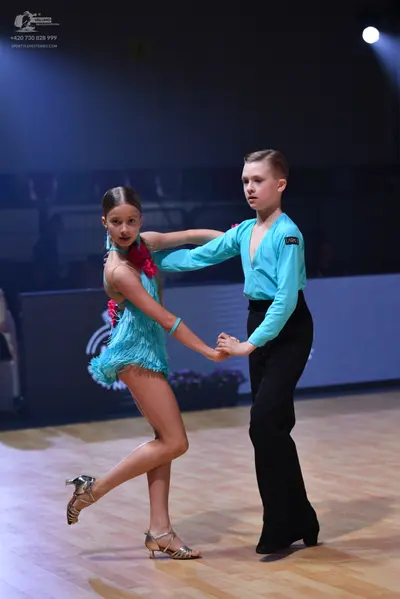 Dancesport competitor: Male dancer: light blue long-sleeved shirt and black trousers