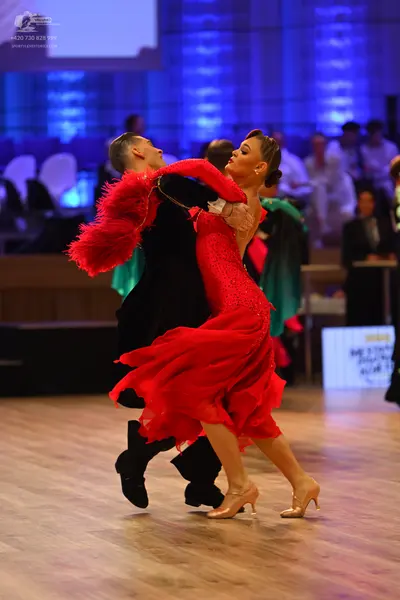 Dancesport competitor: Male dancer: black dance suit and black dance shoes