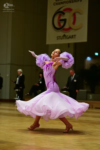 Dancesport competitor: ** Purple Ballgown
*   **Color:** Bright purple
*   **Fabric:**  Appears to be a