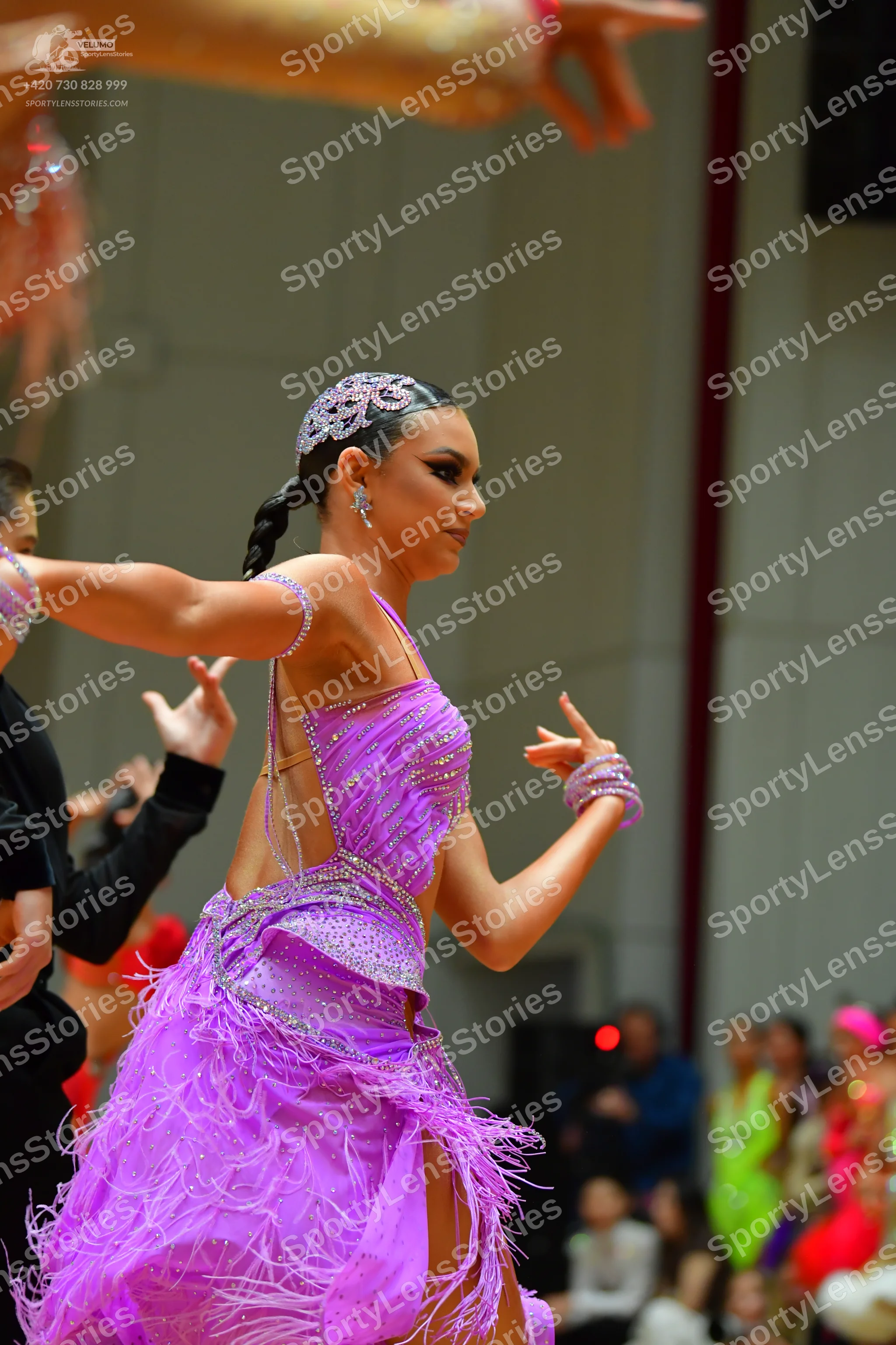 Dancesport competitor: Female dancer: lavender latin dance dress with a sequined bodice and feathered/f