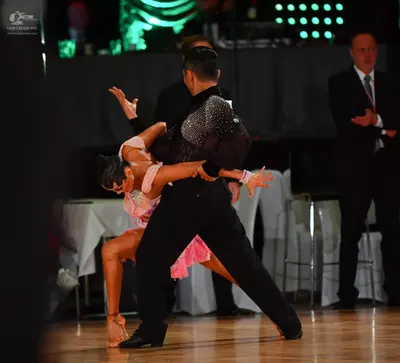 Dancesport competitor: Male dancer: black long-sleeved top with silver sequins on the upper back and sh