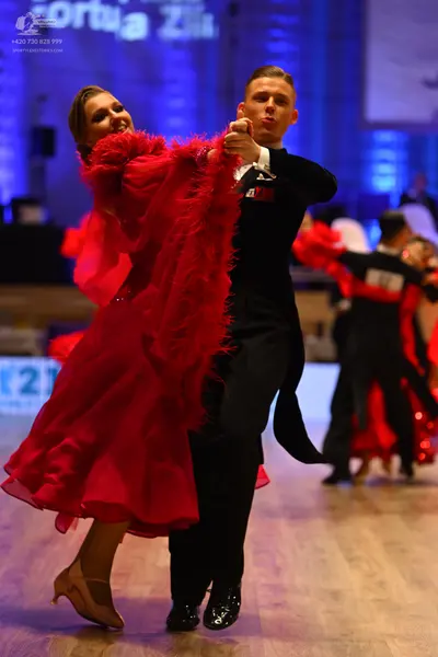 Dancesport competitor: Female dancer: red latin dress with red feathers