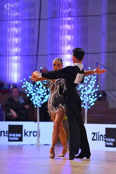 Dancesport competitor: Male dancer: black long-sleeved shirt with a white collar and black trousers