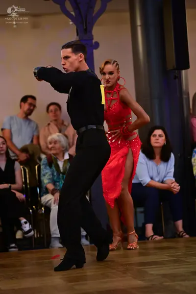 Dancesport competitor: Male dancer: black long-sleeved shirt and black trousers