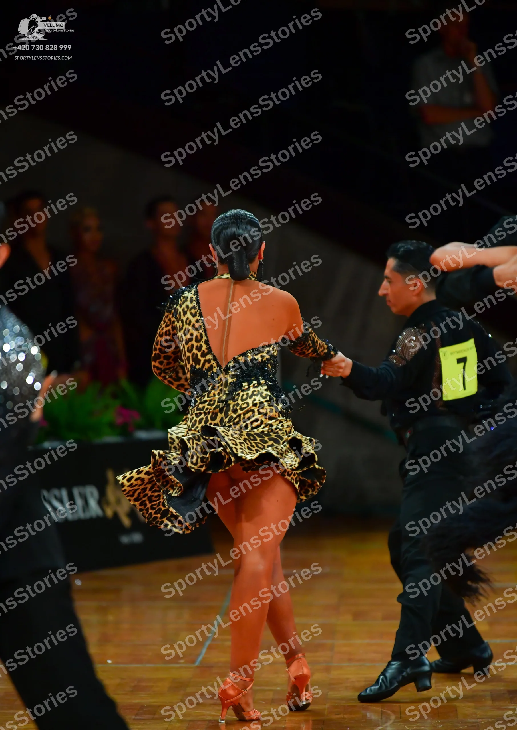 Dancesport competitor: Female dancer: leopard print Latin dress with a flared skirt