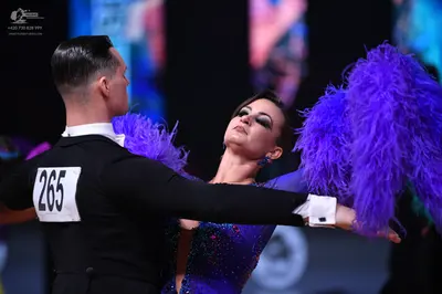 Dancesport competitor: Male dancer: black suit with a white shirt and white bow tie