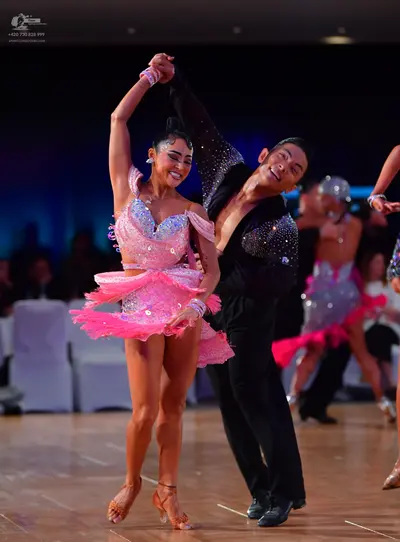 Dancesport competitor: Male dancer: black long-sleeved shirt with silver sequin embellishments and blac