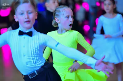 Dancesport competitor: Male dancer: white long-sleeved shirt with a pleated front, black bow tie, and b