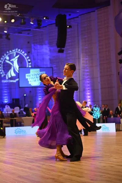 Dancesport competitor: Male dancer: black suit with a white shirt