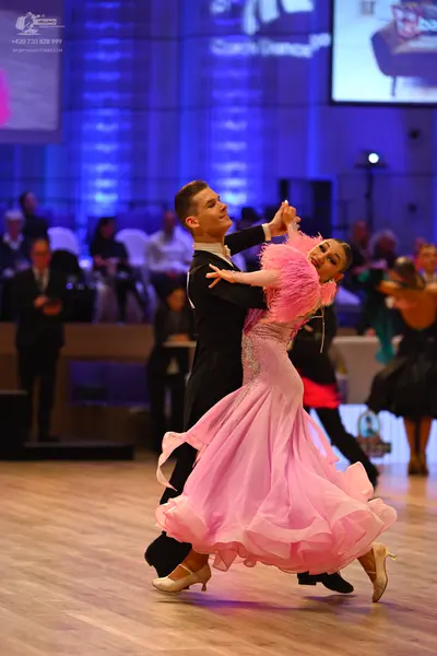 Dancesport competitor: Male dancer: black ballroom suit with a white shirt