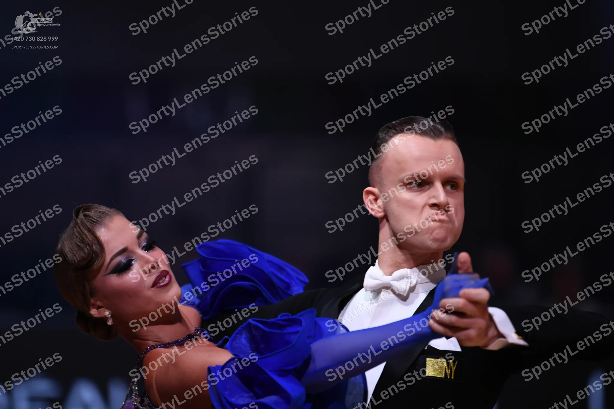 Dancesport competitor: Male dancer: black suit with a white shirt and white bow tie