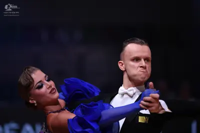 Dancesport competitor: Male dancer: black suit with a white shirt and white bow tie