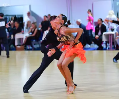 Dancesport competitor: Male dancer: black long-sleeved shirt and black trousers