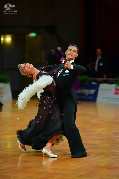Dancesport competitor: Male dancer: black suit, white shirt, and black bow tie