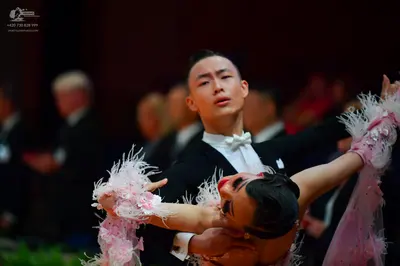 Dancesport competitor: Male dancer: black suit with white shirt and white bow tie