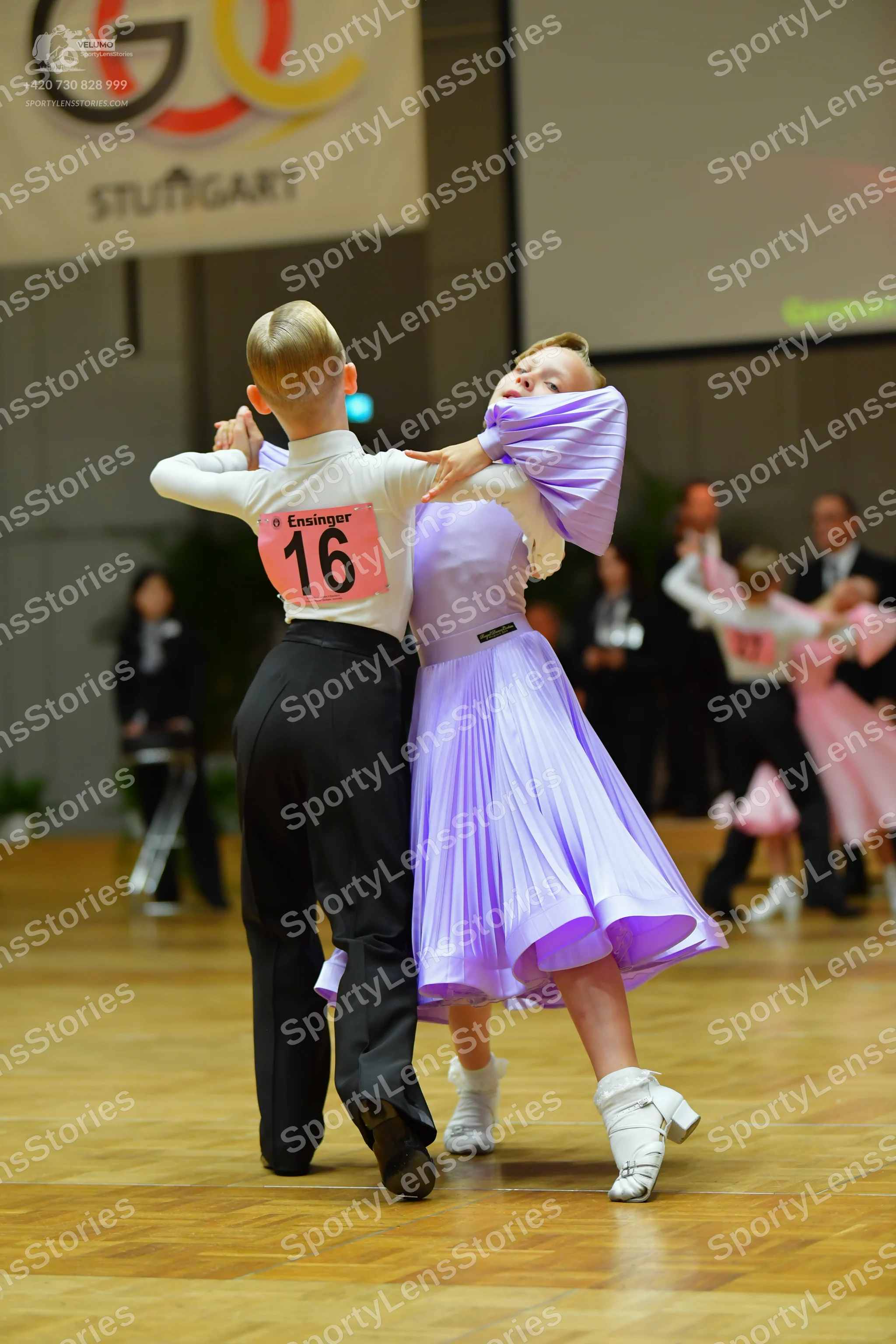 Dancesport competitor #16: Male dancer in foreground: white long-sleeved shirt and black trousers