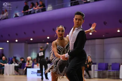 Dancesport competitor: Male dancer: black long-sleeved dance shirt with white collar detail and black t
