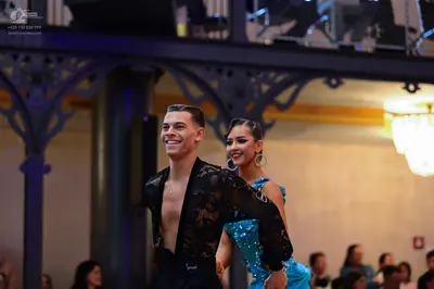 Dancesport competitor: Male dancer: black semi-transparent long-sleeved shirt with a lace-like pattern 
