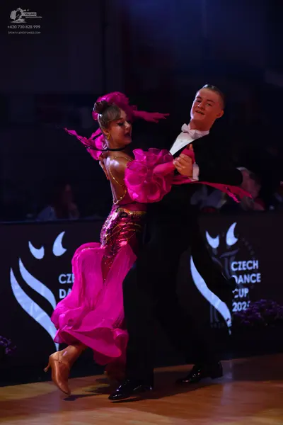 Dancesport competitor: Male dancer: black suit with a white shirt and white bowtie