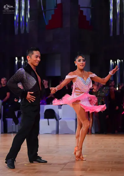 Dancesport competitor: Male dancer: black long-sleeved shirt with silver sequins on the shoulder and bl