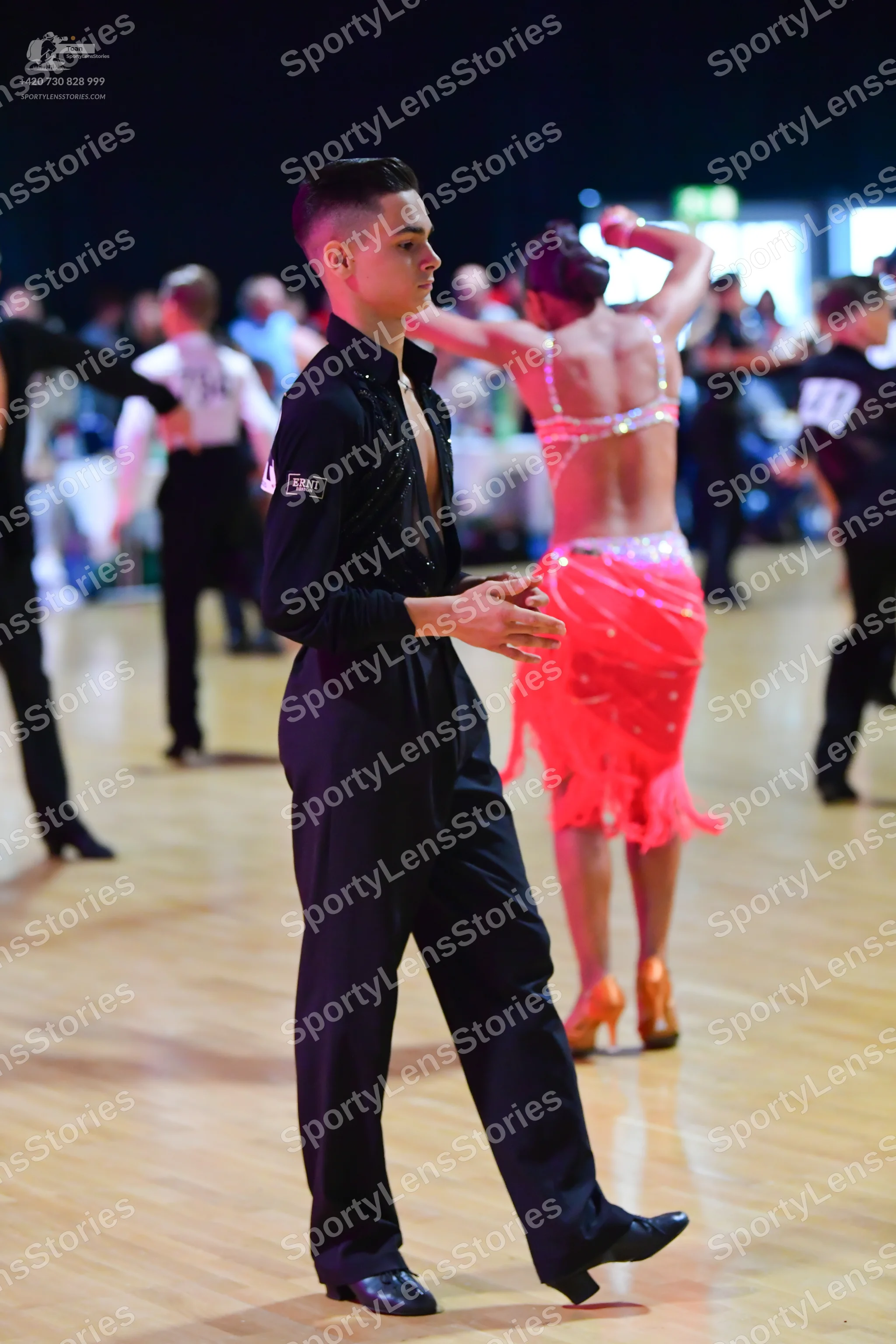 Dancesport competitor: Male dancer: black long-sleeved shirt and black trousers