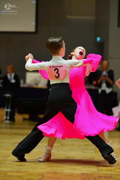 Dancesport competitor: Male dancer: white long-sleeved shirt and black trousers