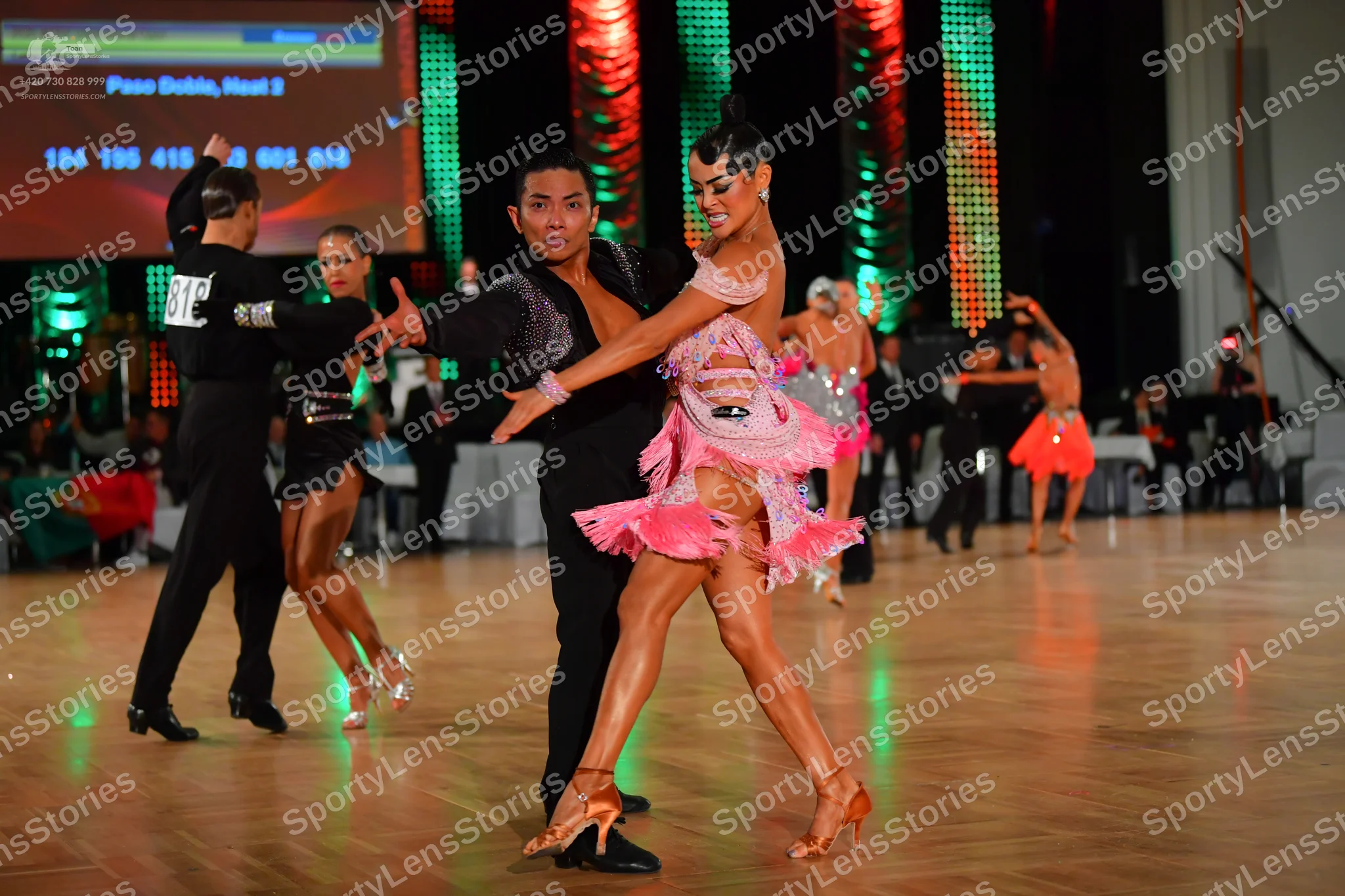 Dancesport competitor: Male dancer (foreground): black long-sleeved shirt and trousers