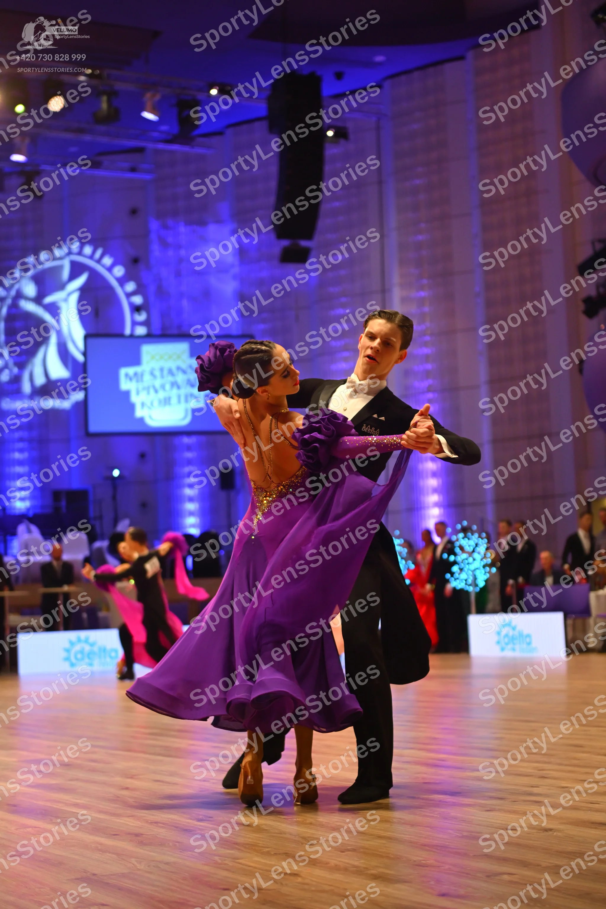 Dancesport competitor: Male dancer: black ballroom suit with a white shirt and white bowtie