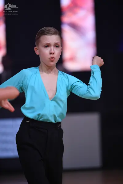 Dancesport competitor: Male dancer: light blue long-sleeved shirt with a deep V-neck and black trousers
