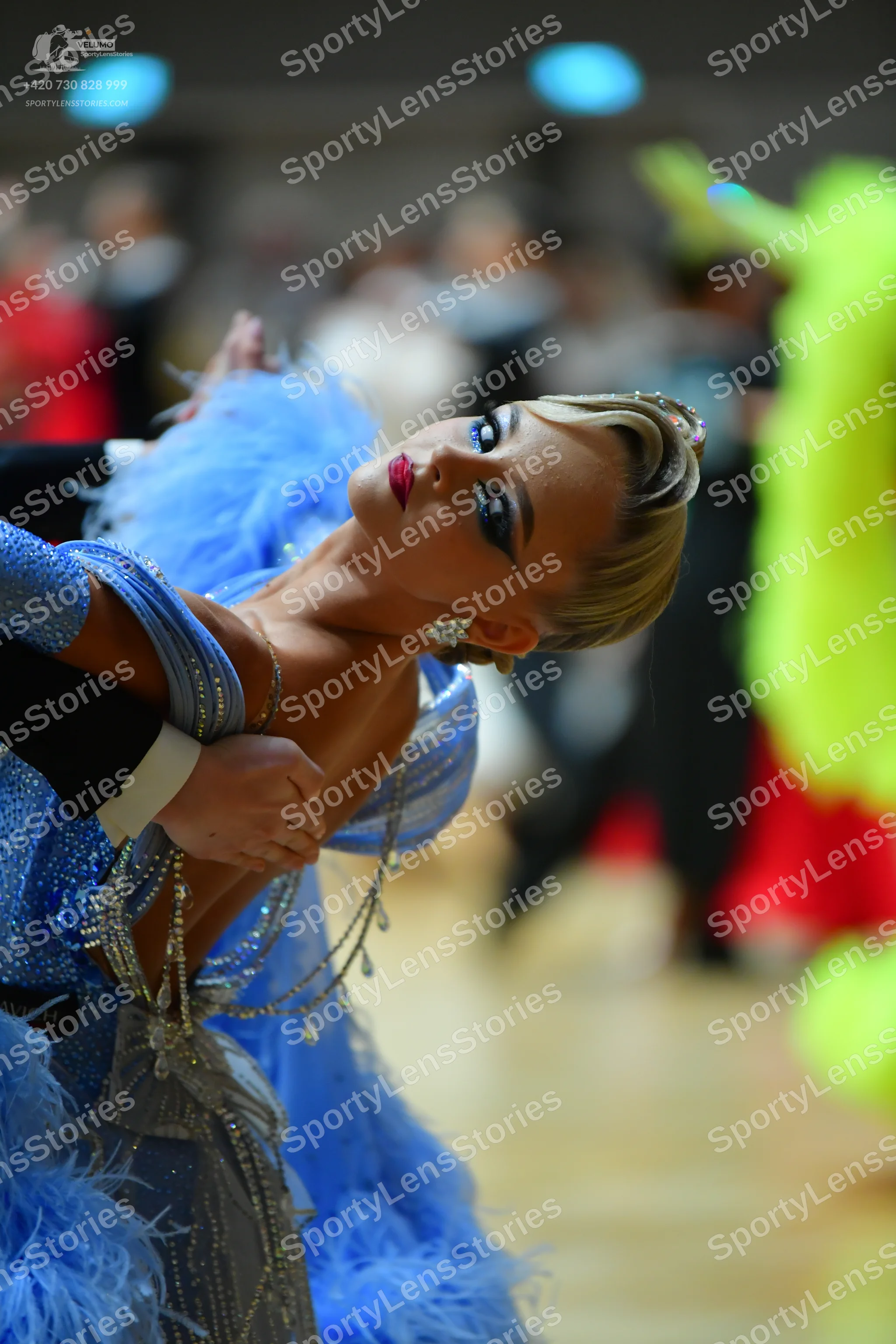 Dancesport competitor: Female dancer: Blue latin dress heavily embellished with silver sequins and rhin