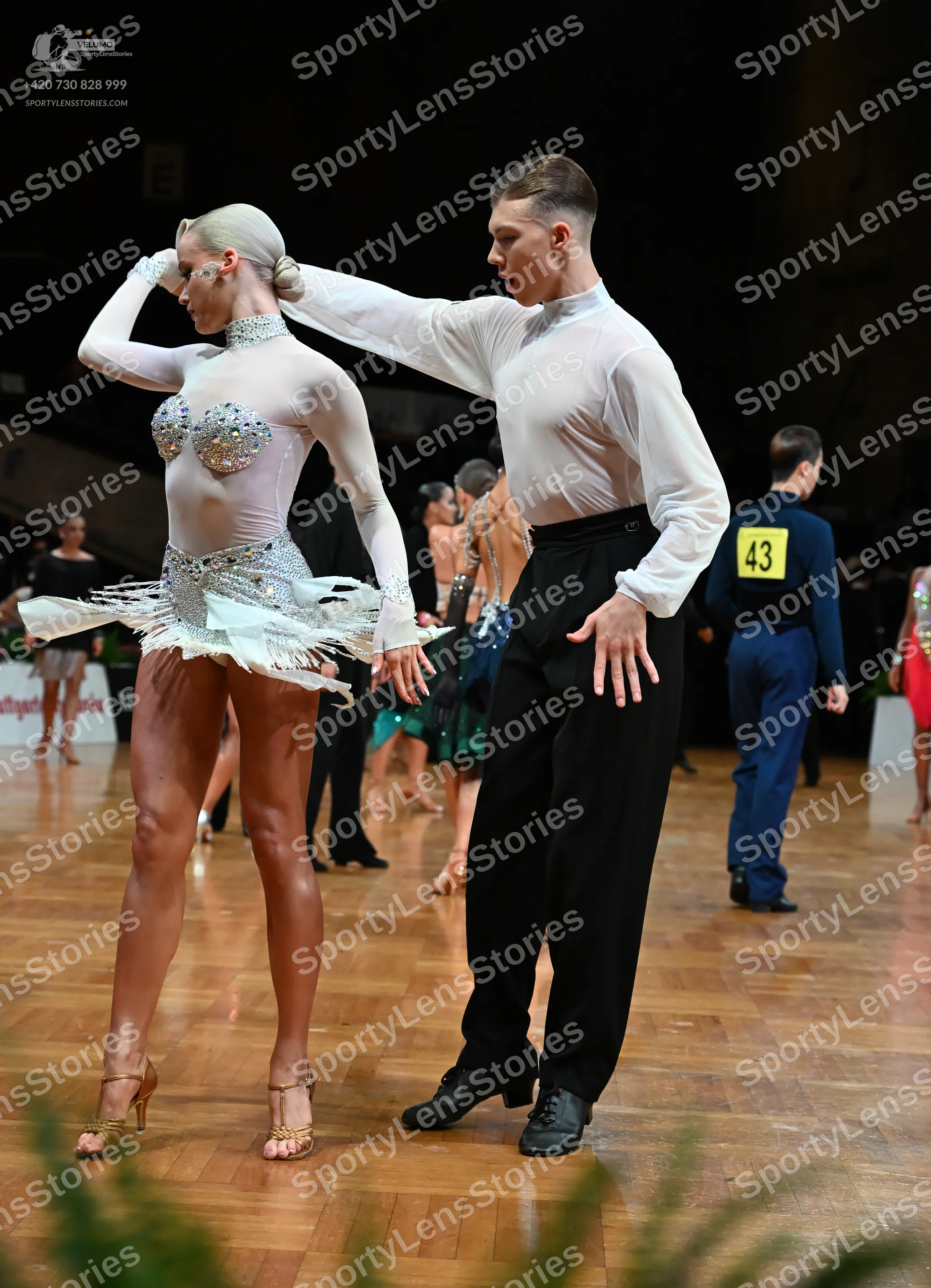 Dancesport competitor #43: Female dancer: white long-sleeve bodysuit with sequins and rhinestones, sheer sl