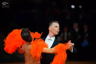 Dancesport competitor: Male dancer: black suit with a white shirt and white bowtie