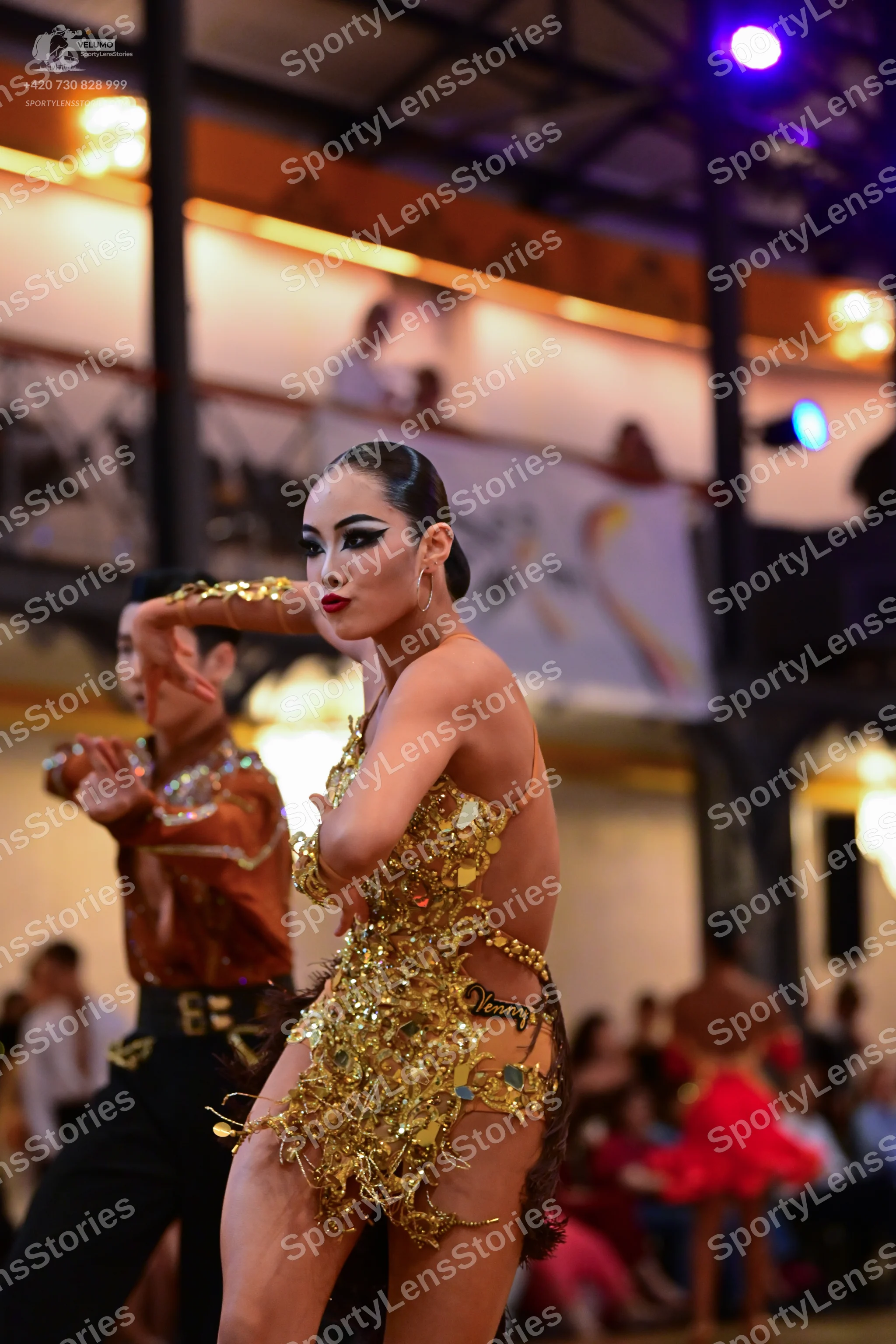 Dancesport competitor: Male dancer: bronze satin-style shirt with sequin embellishments and black trous
