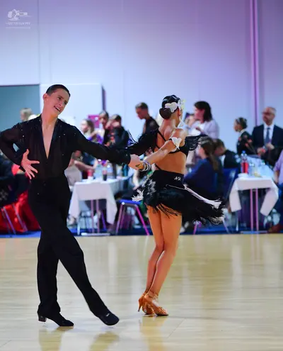 Dancesport competitor #12: Male dancer: black long-sleeved shirt with small crystals and black dance trouse