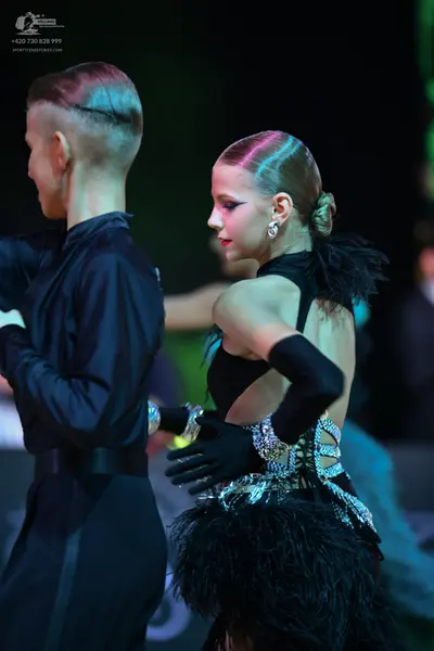 Dancesport competitor: Male dancer: black long-sleeved dance top