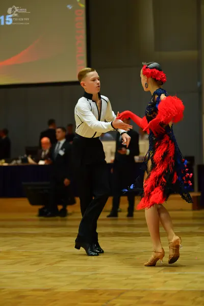 Dancesport competitor: Male dancer: white long-sleeved shirt with black trim and black trousers