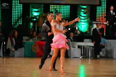 Dancesport competitor: Male dancer: black long-sleeved top with sequins on the shoulders and black trou