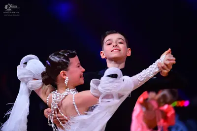 Dancesport competitor: Female dancer: White costume with extensive pearl and bead embellishments, featu