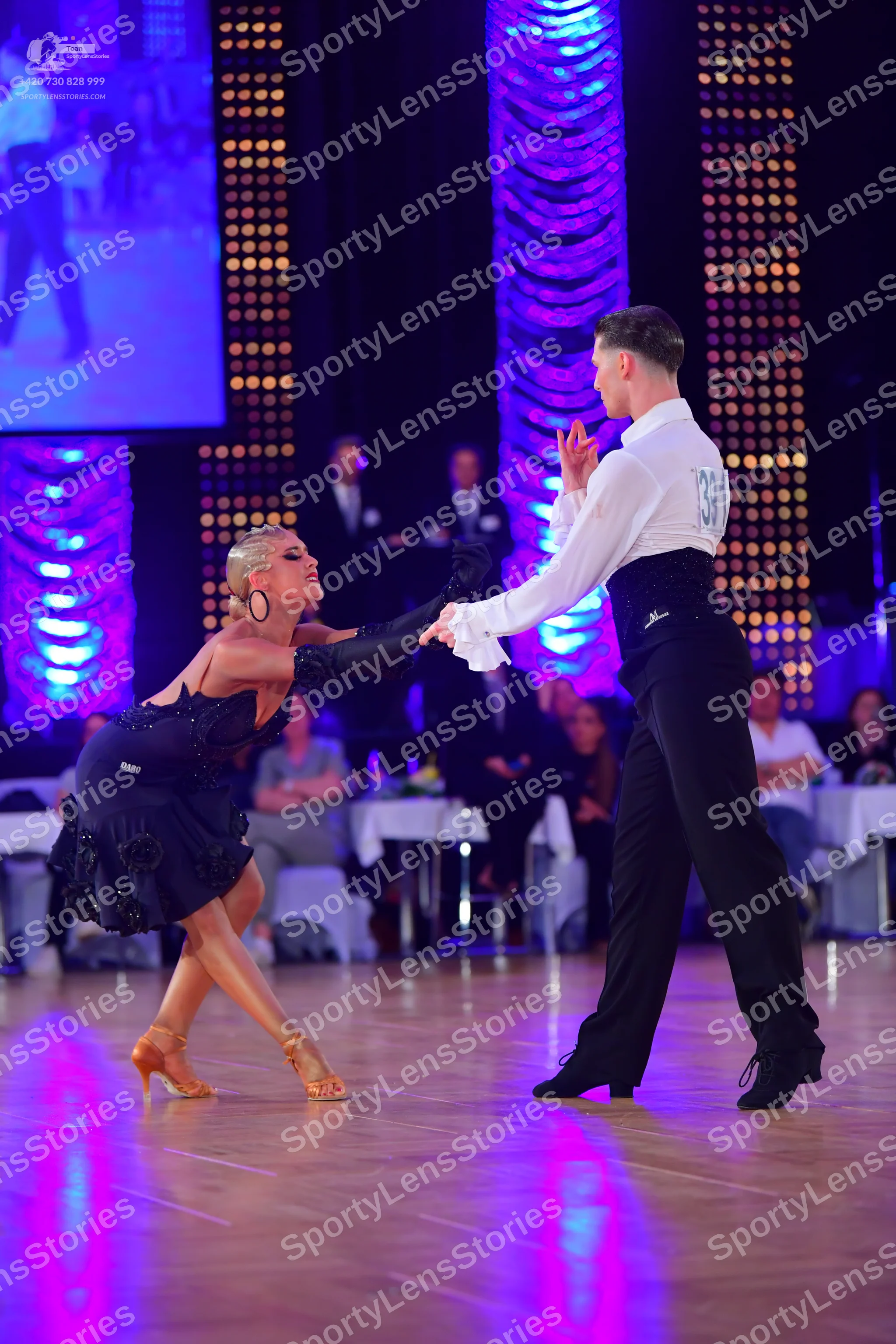 Dancesport competitor #38: Male dancer: white long-sleeved shirt with ruffled cuffs, black high-waisted wai