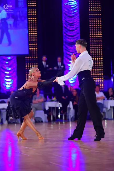 Dancesport competitor #38: Male dancer: white long-sleeved shirt with ruffled cuffs, black high-waisted wai
