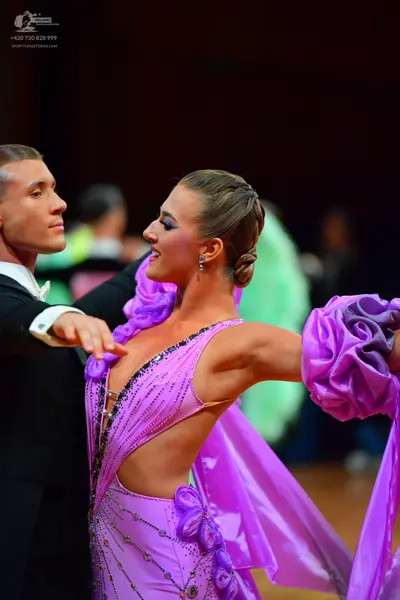 Dancesport competitor: Male dancer: black suit with a white shirt