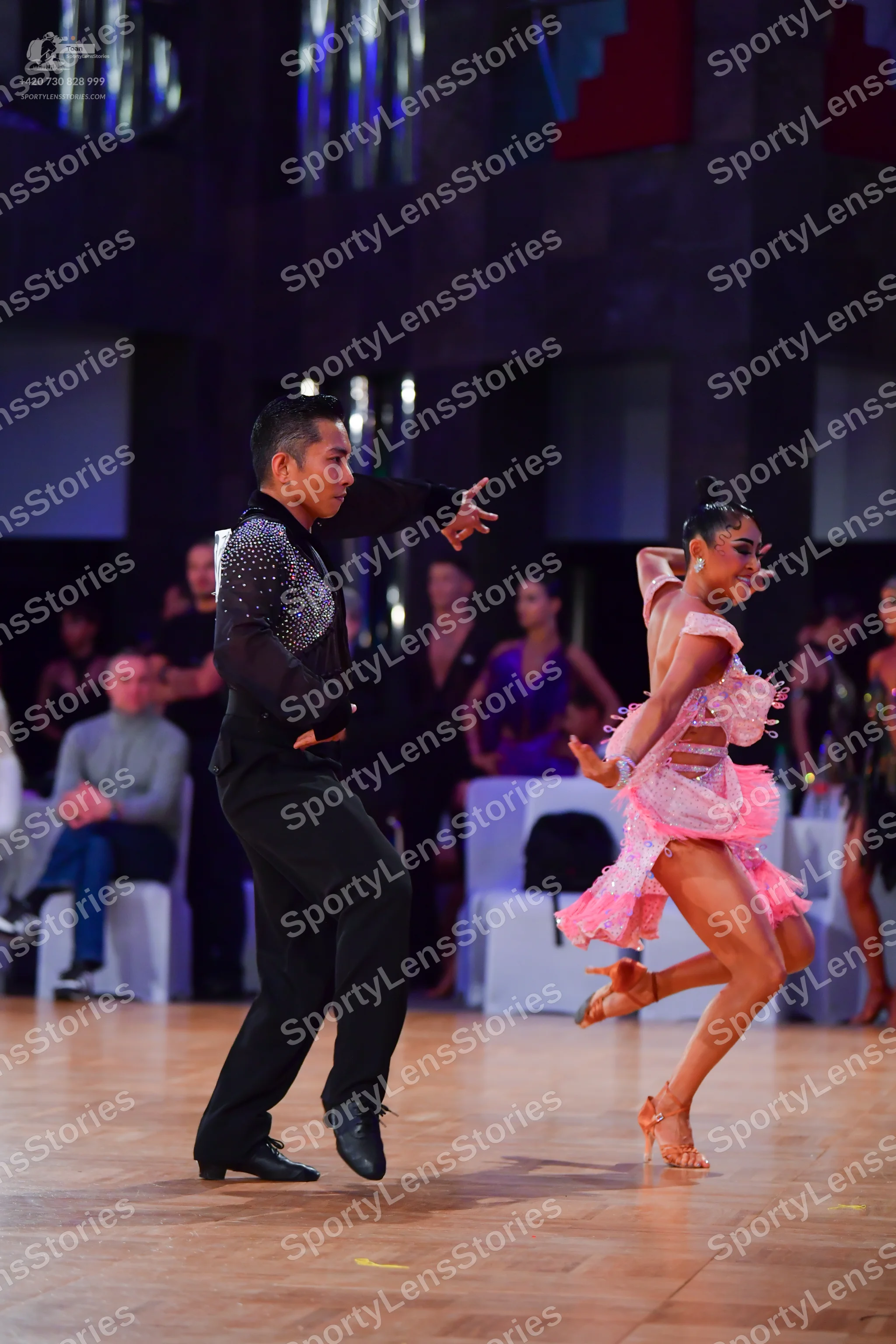 Dancesport competitor: Male dancer: black long-sleeved shirt with silver sequins on the shoulder and bl